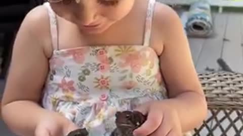 Adorable child so exited to have frogs as her pet