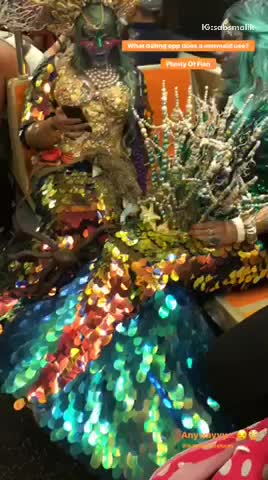 Two people mermaid costumes subway train