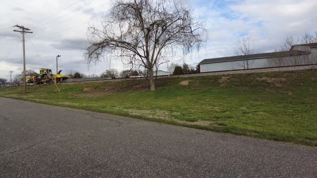 Riding A Bike Past CSX Track Equipment On A Hill In Lincolnton