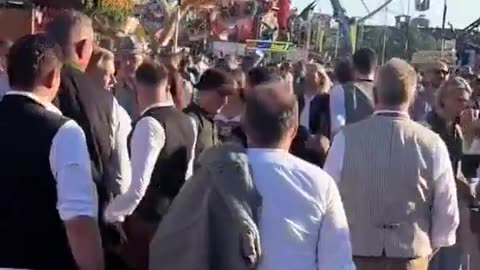 A migrant walks through Oktoberfest in Germany groping random women and