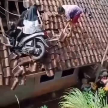 It's a rare incident... how come a motorbike can climb onto the roof of a house