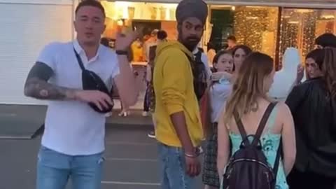 Guy decides to dance do indian dance next to indian guy