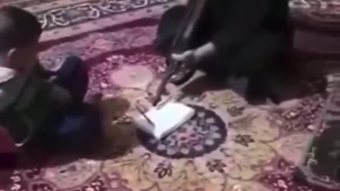 Muslim father threatens son with rifle to memorize Quran