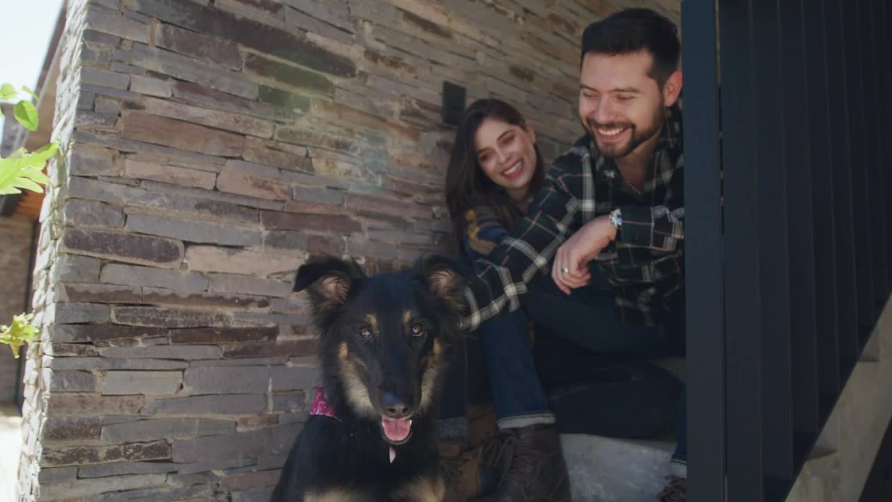 Happy couple petting their dog