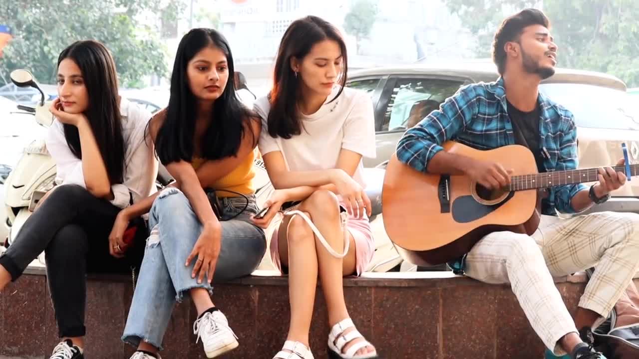 Singing with acoustic guitar in front of beautiful women