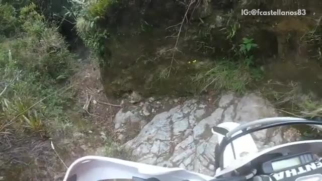 Motorcycle in narrow trail falls over