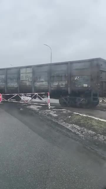A tractor pulls freight wagons along the rails