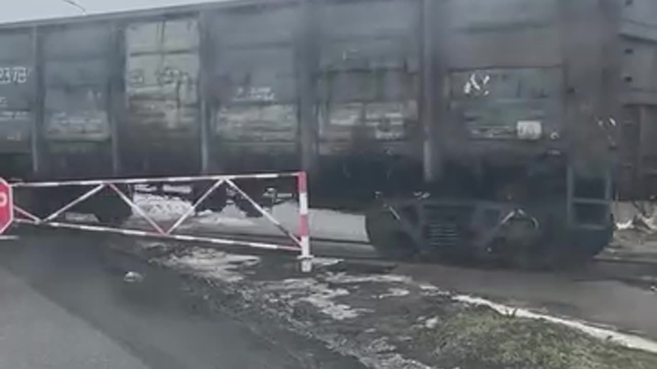 A tractor pulls freight wagons along the rails