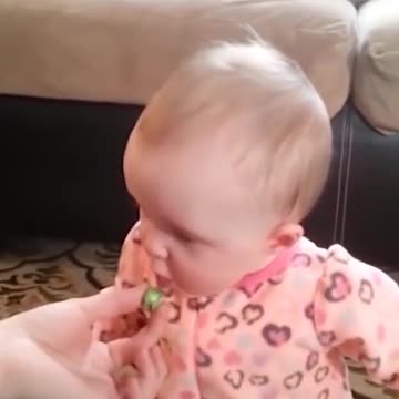 Baby girl tastes olives for the first time