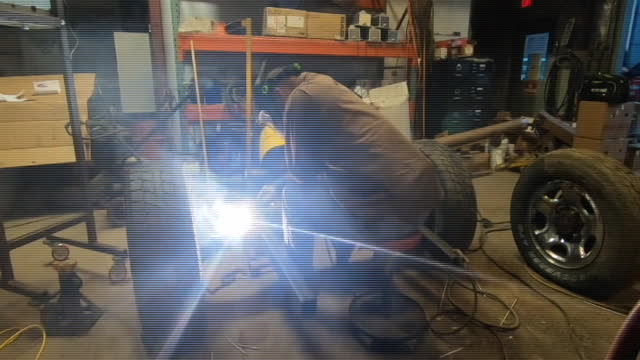 Installing axle trusses for a custom suspension setup.