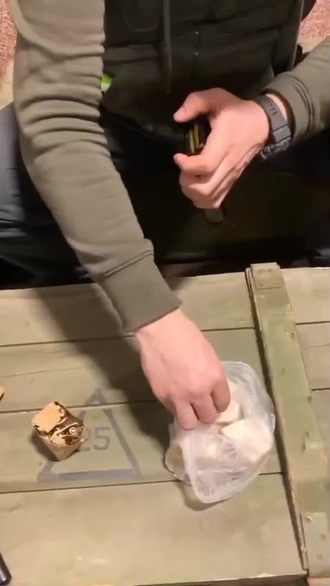 Ukrainian Soldiers on duty lubricate their ammo cartridges with pork lard