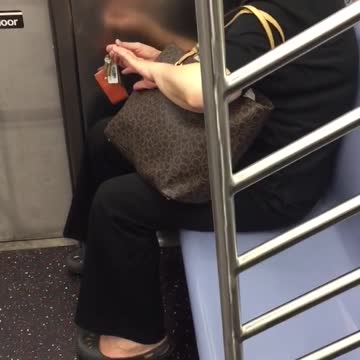 Lady clipping nails on subway