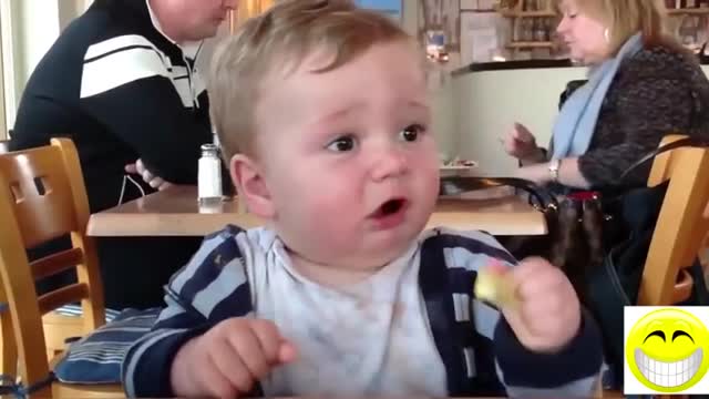 Baby trying lemon for the first time.