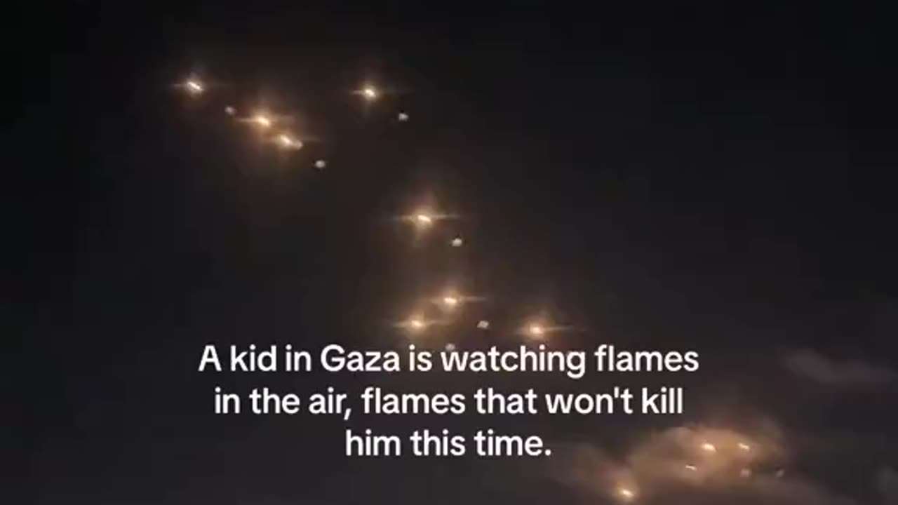 A kid in Gaza is watching flames in the air, flames that won't kill him this time