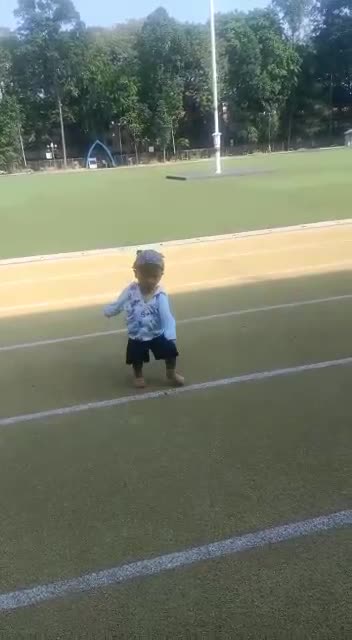 a little baby just learning to step on the earth