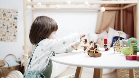 Cute Small Girl Playing with Toys.