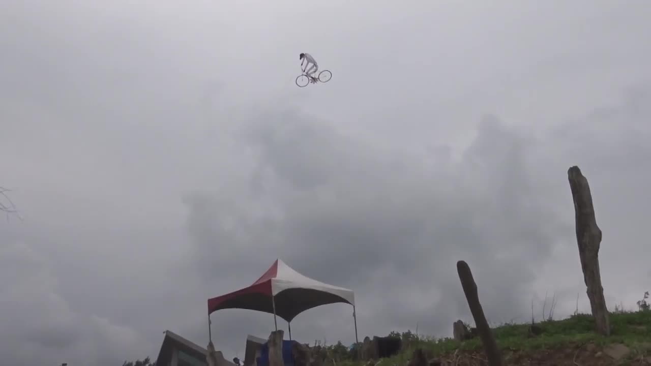 Guy riding bike is the coolest kite ever!