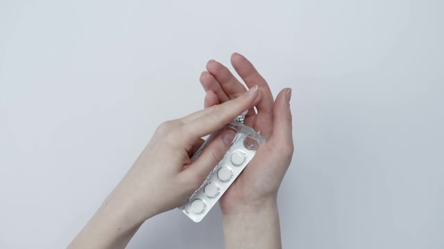 Taking Medicine From Its Packaging