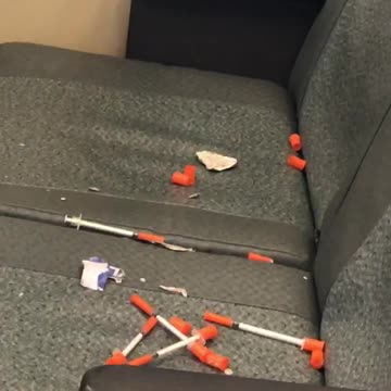Pile of used needles left on train seats