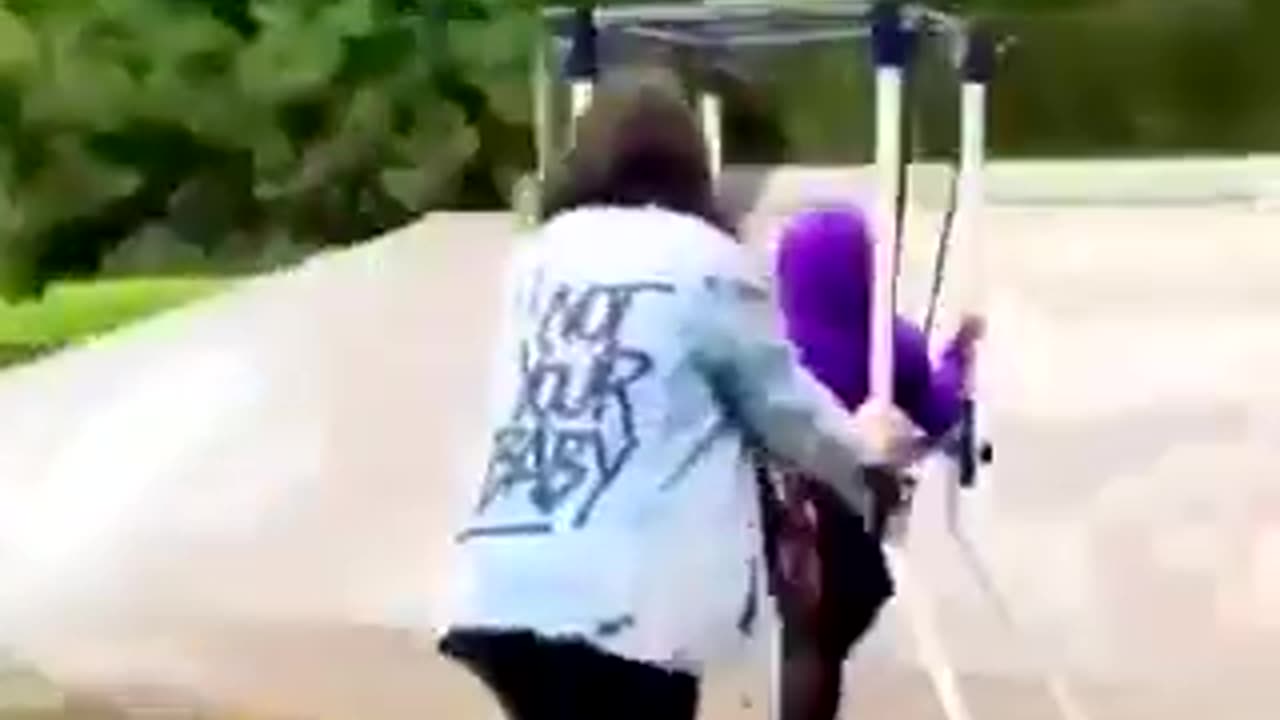 Mommy helping her son with cerebral palsy skateboard for the first time..