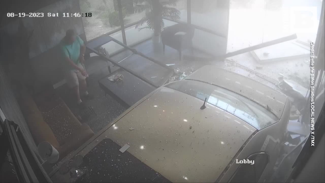 Car Narrowly Misses Lobby Occupant as it Crashes into Business Building