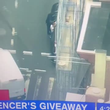 Several people hold onto a vehicle with Twitch streamer Kai Cenat reportedly inside