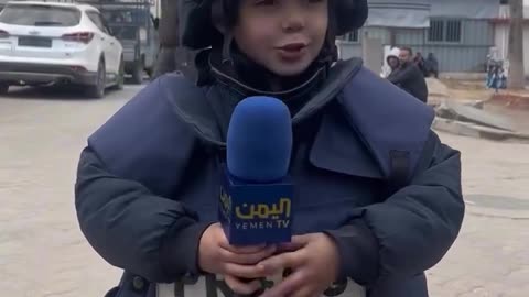 A Pal esti nian child wearing a journalist’s uniform