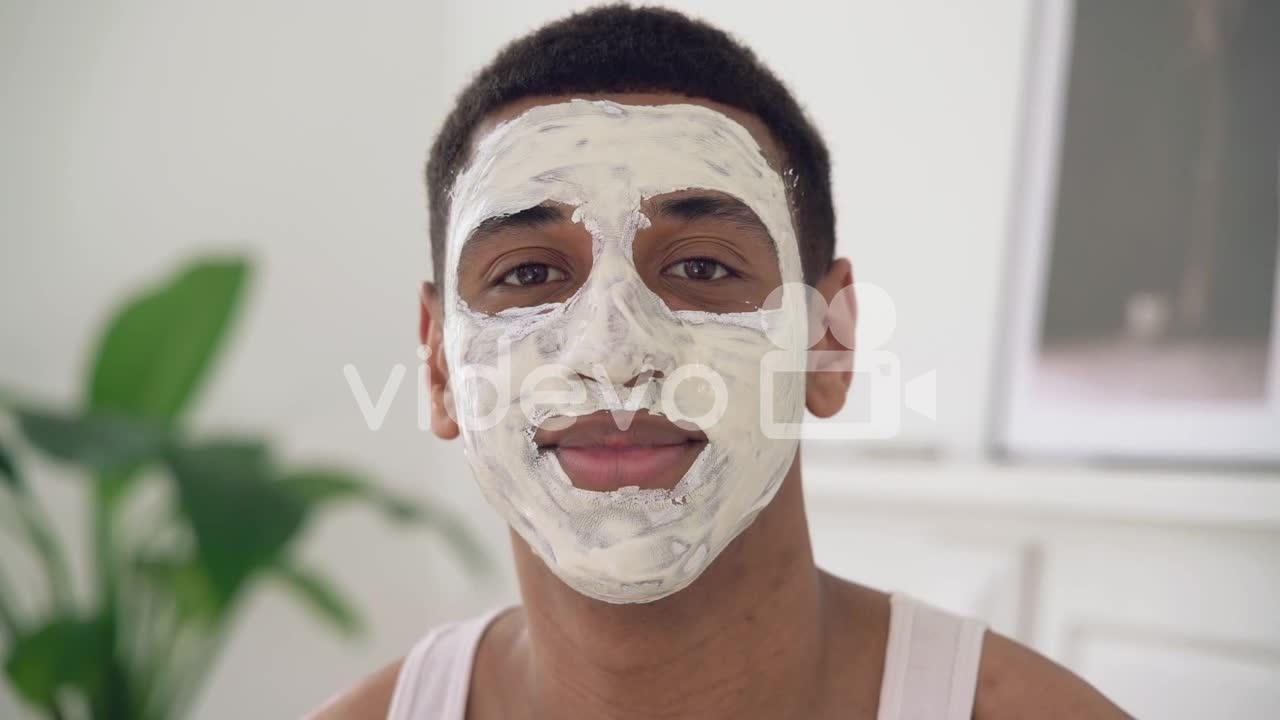 Portrait Of A Handsome Black Man With Facial Mask Looking At Camera And Smiling