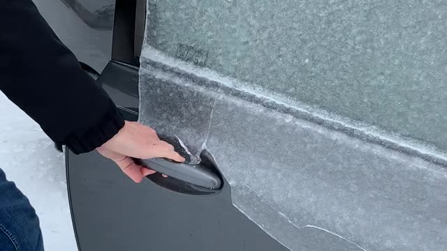 Opening the Door on an Ice-Covered Car