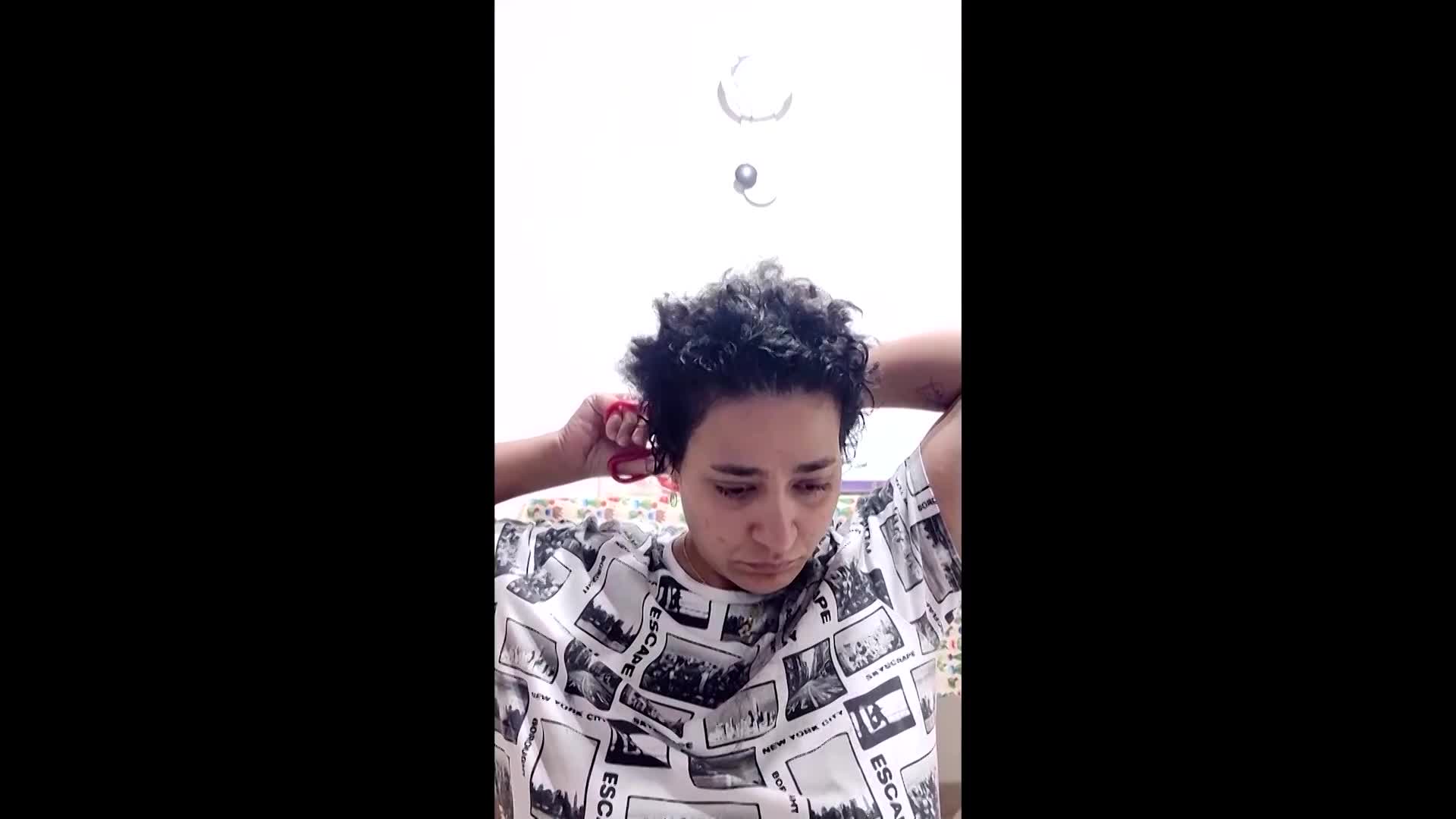 Woman cuts hair in protest over Iran womans death