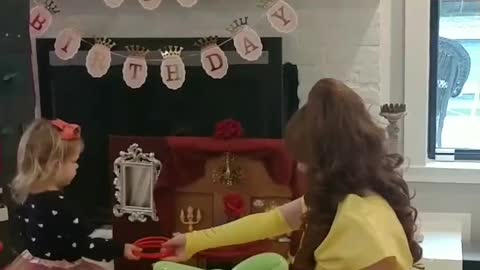 Houston princess party character belle plays ring around the rose game on our theme game board