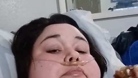 Overweight woman eating food in hospital
