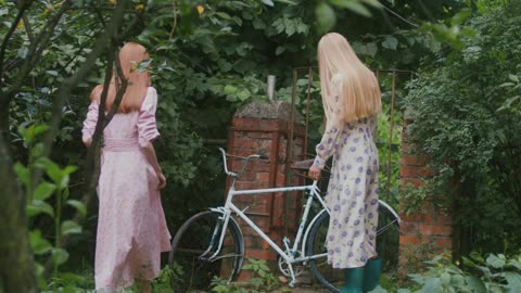 Women Walking while Looking at the Bicycle More info Share