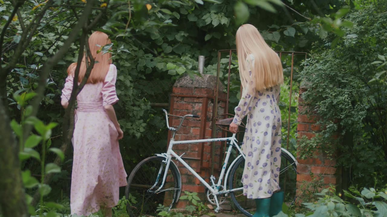 Women Walking while Looking at the Bicycle More info Share