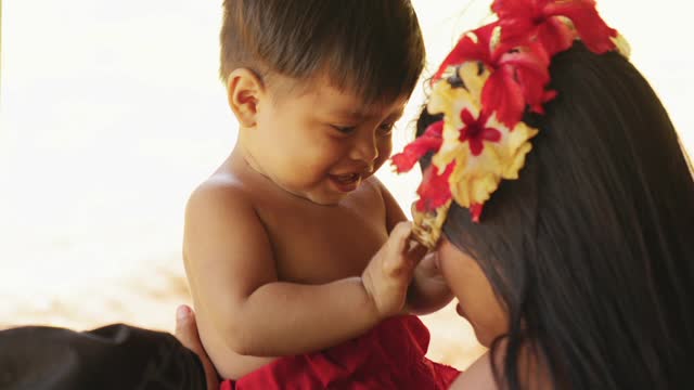 A Baby playing with his mother ..