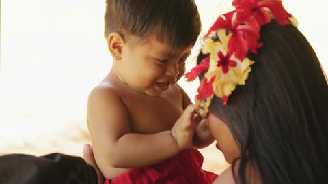 A Baby playing with his mother ..