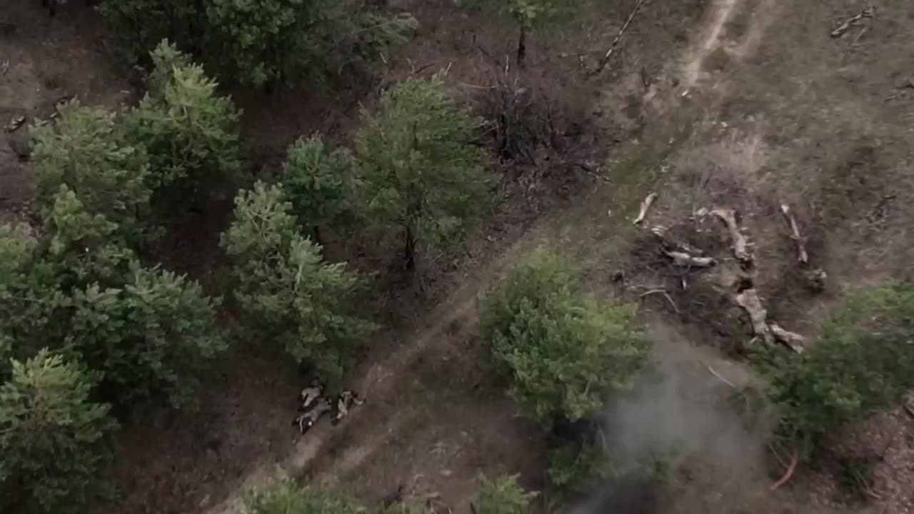 POV from RF UAV of UAF being shelled and trying to save their comrade