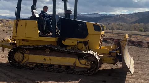 Kid operating bulldozer like a pro