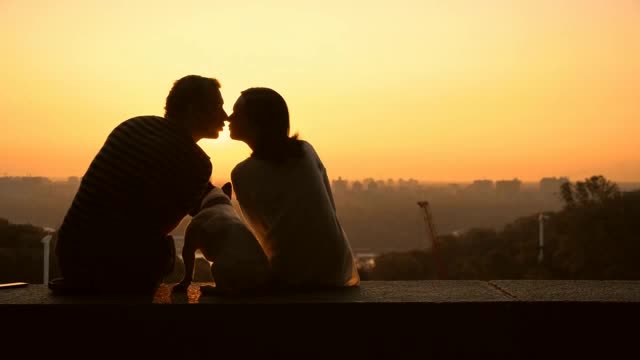 A couple in love watching a romantic sunset