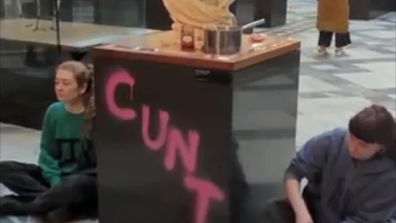 Protesting economic hardships in Britain, statute vandalized is of "Queen" Victoria
