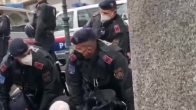 Vienna: Austria. Communistic police take out a 'elderly lady'