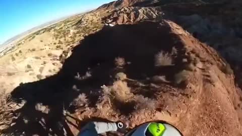 Person Rides Bike on the Edge of the Ridge