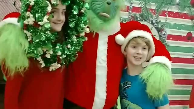 Wear the wreath photo prop at a Christmas party in Katy TX with the Grinch