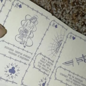 Playing cards with prison tattoos and their values.