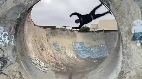 Guy Turns Upside Down While Skateboarding Inside Loop At Skatepark