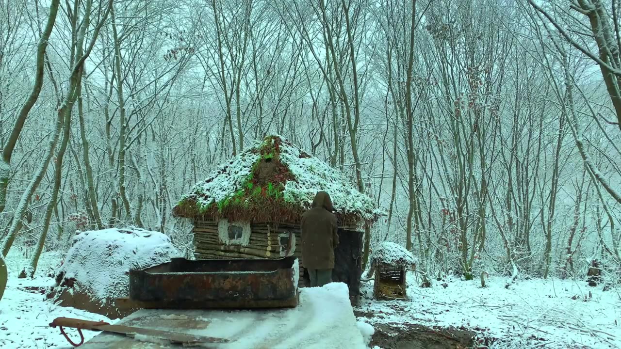 Building complete and warm survival shelter Bushcraft log cabin, grass roof & fireplace with clay.