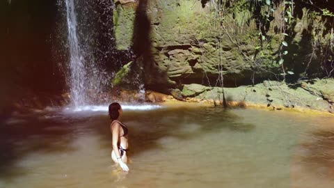 beautiful young girl in the waterfall