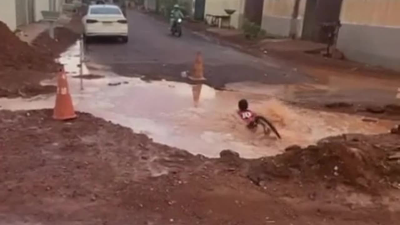 Boy Rides His Bike Into Giant Pothole