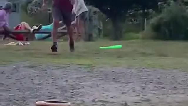 Fence Behind Him Breaks Simultaneously as Man Hits Baseball