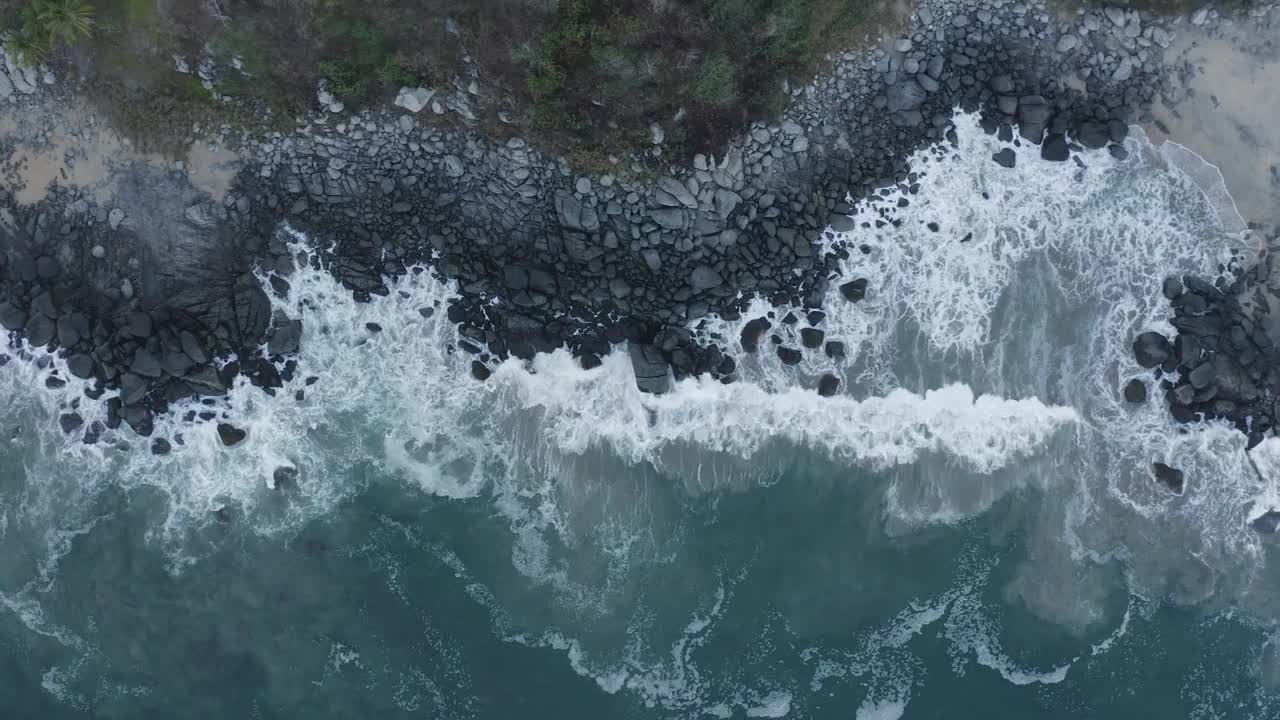 Top aerial shot of seashore with rocks